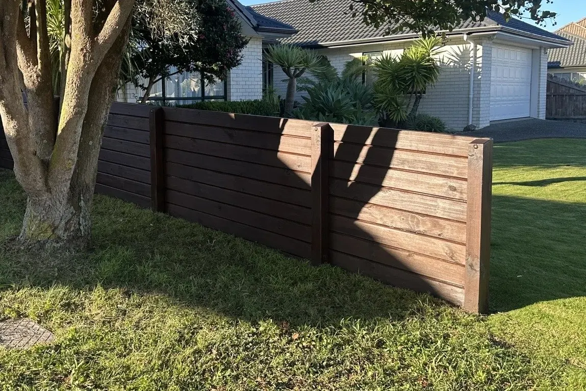 New dark-stained timber boundary fence built by Handyman Botany in Botany, East Auckland
