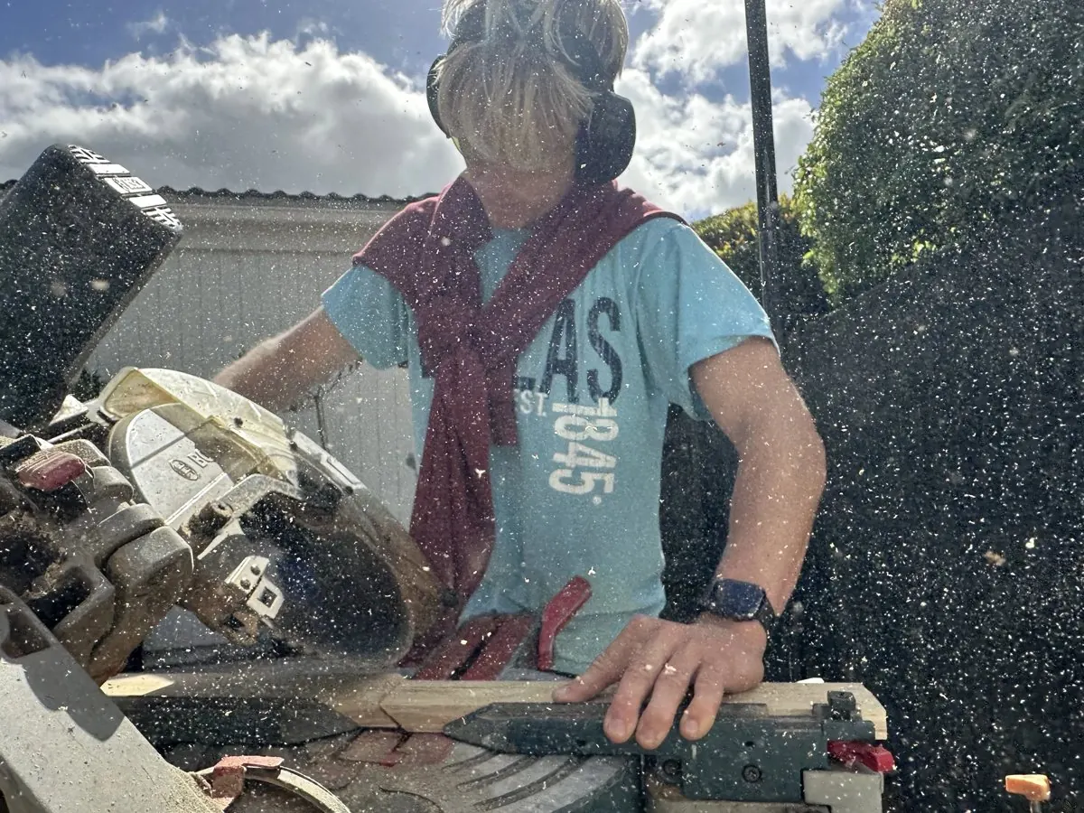 Cutting timber for a new door installation in Half Moon Bay, East Auckland