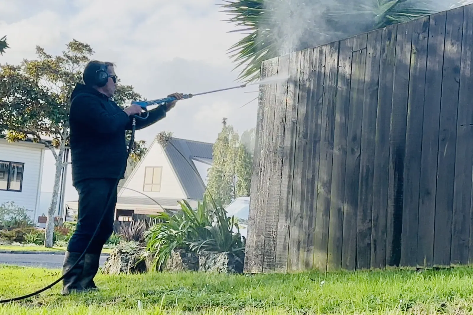 Rinat water blasting a weathered timber fence in East Auckland