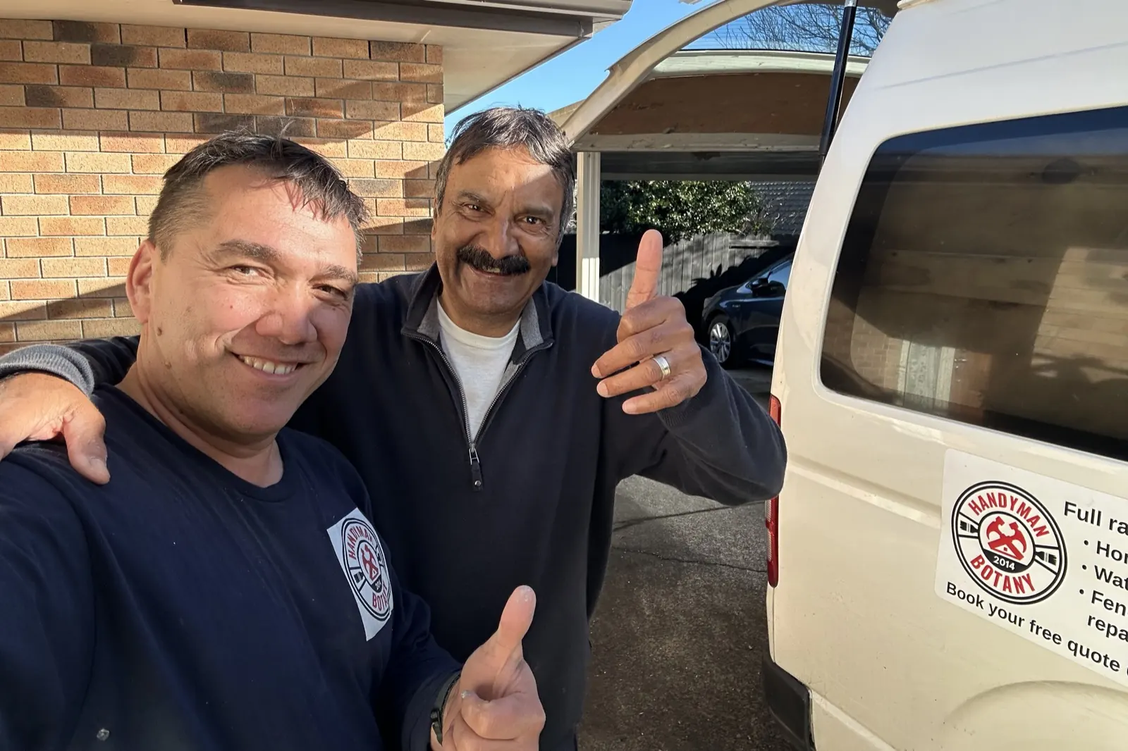 Rinat from Handyman Botany with a happy customer beside the branded work van in East Auckland
