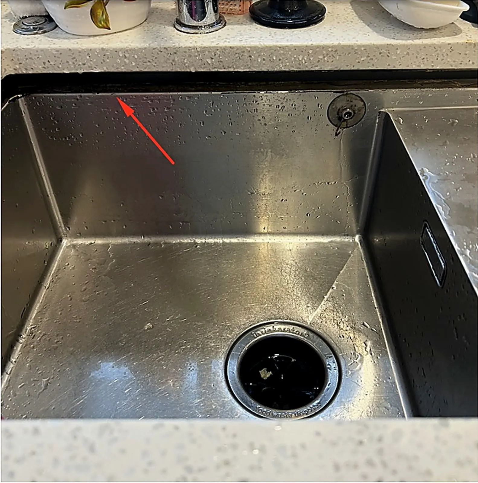Before: gap where the kitchen sink pulled away from the stone benchtop in East Tamaki