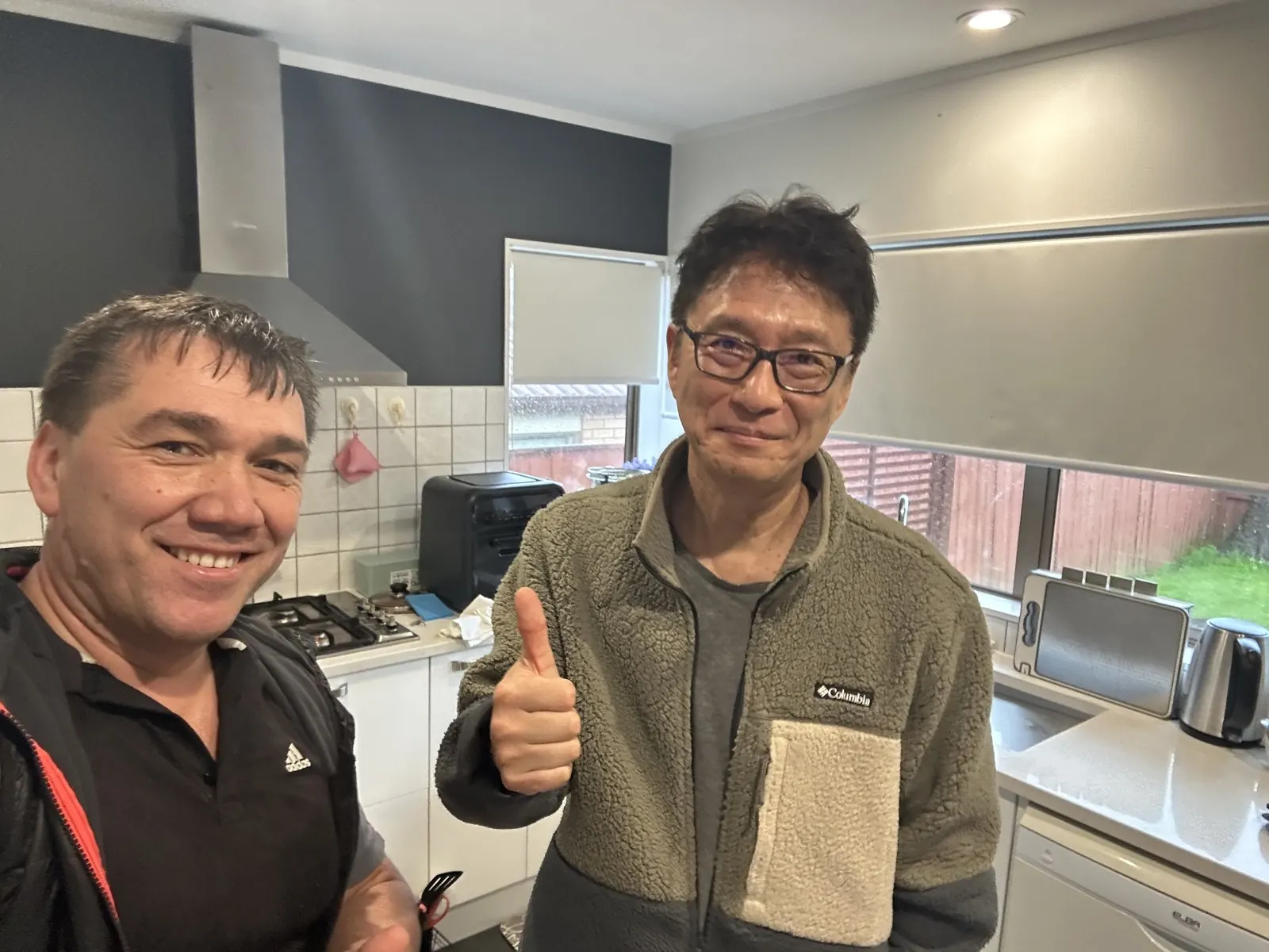Rinat from Handyman Botany with a happy customer after completing the kitchen sink repair in East Tamaki