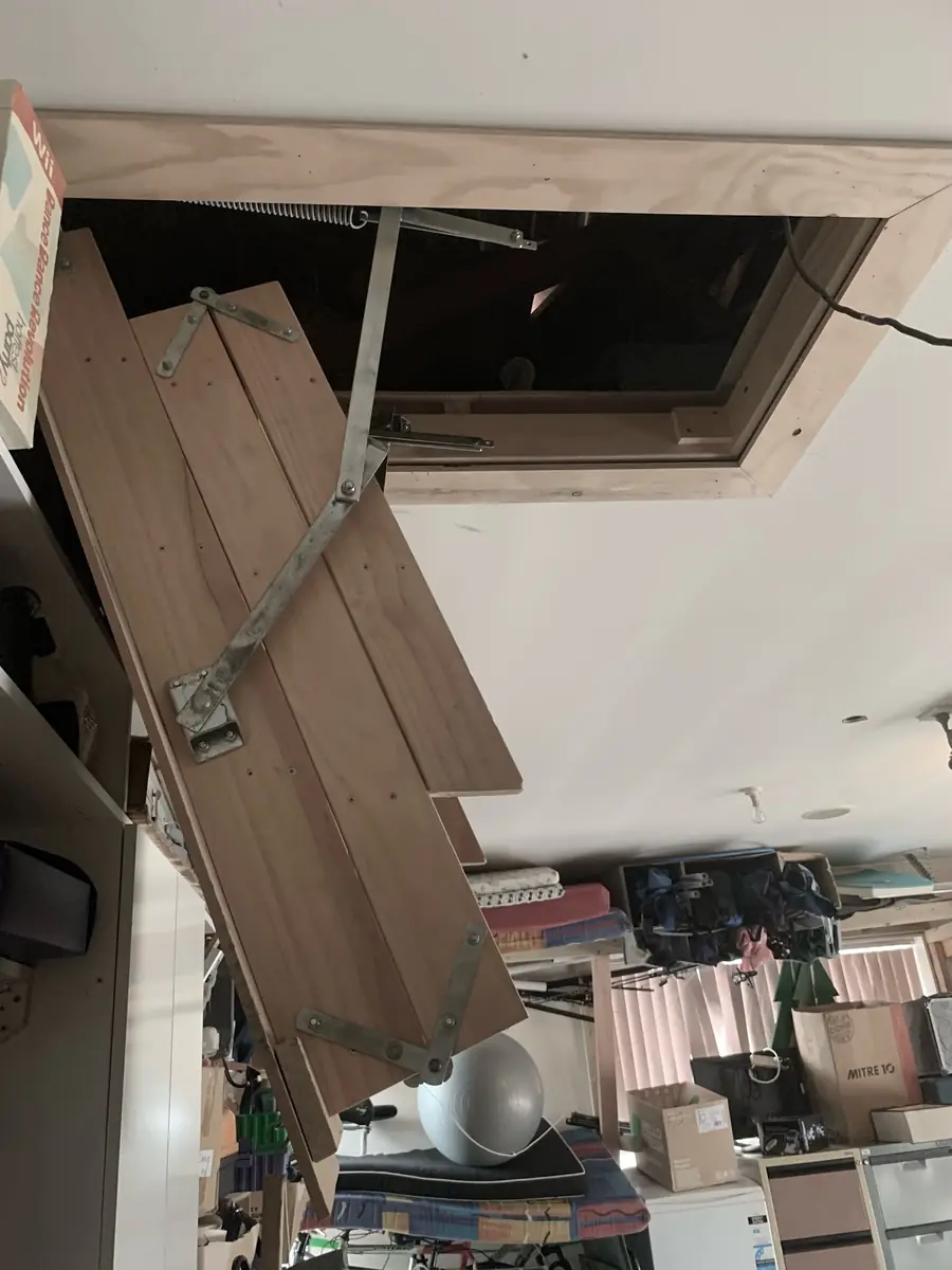 Enlarged manhole opening with new timber framing around it and the folded ladder unit in place