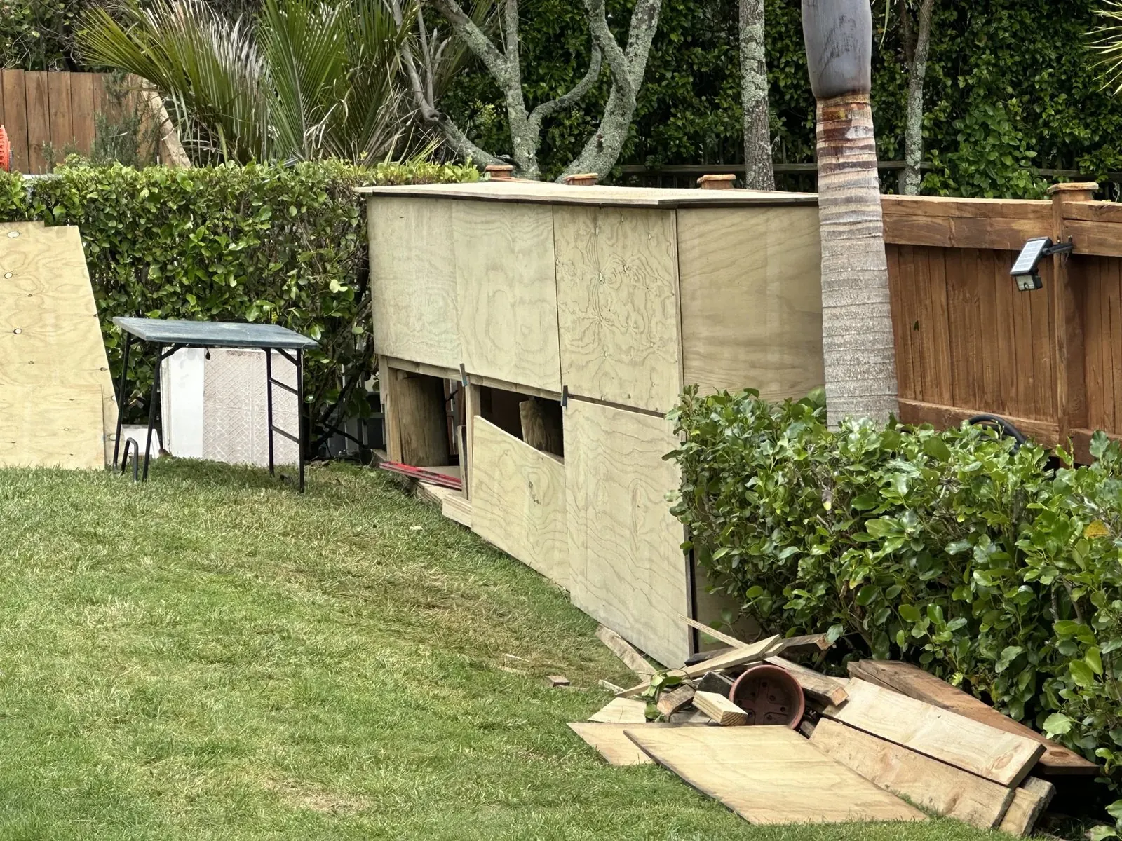 Plywood cladding fitted to a custom storage shed built across a sloping garden