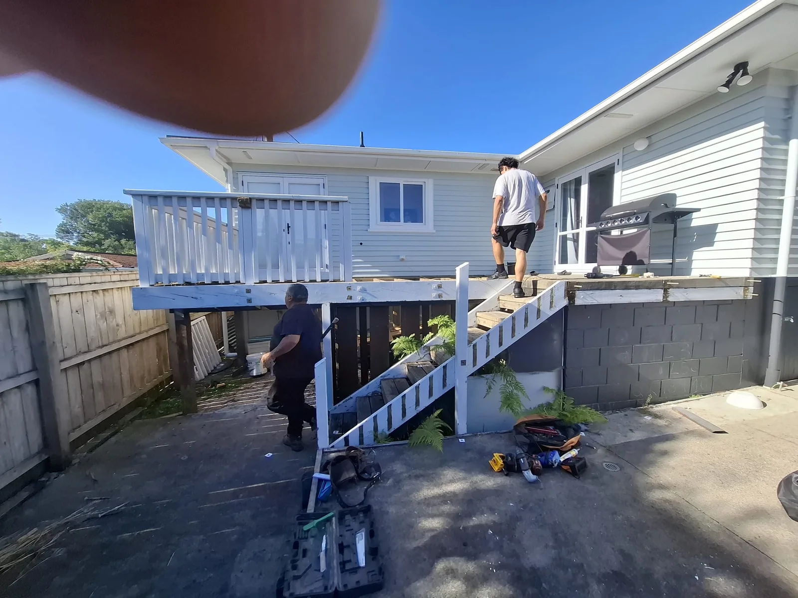 The old weathered timber deck with painted balustrade in Pukekohe before replacement