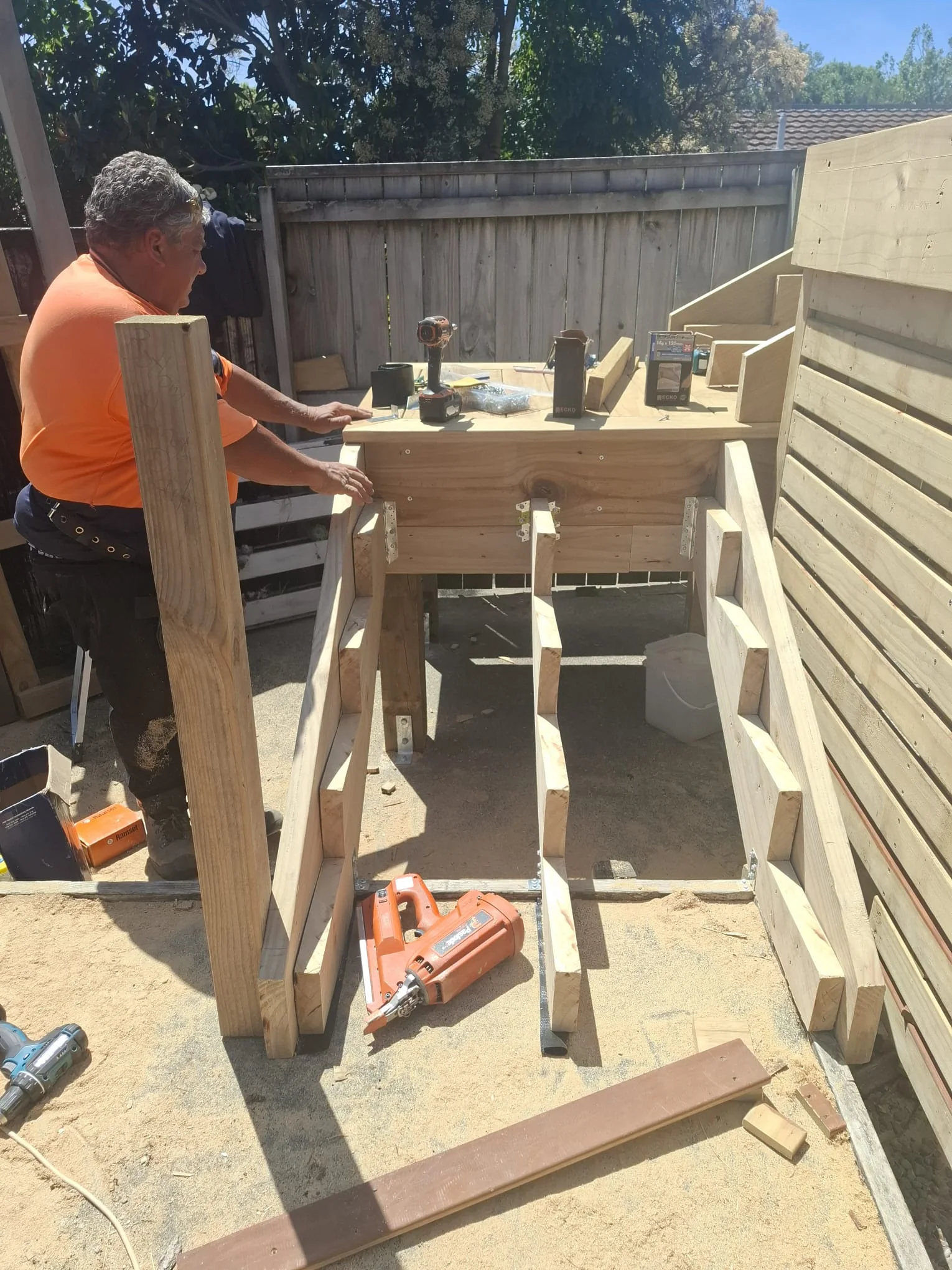 Carpenter building the new deck steps and balustrade on site