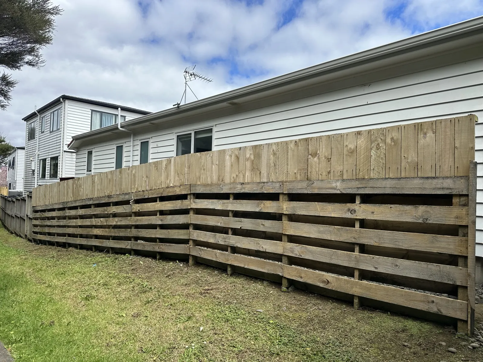 The full run of fence washed back to bare timber before painting, Sunnyhills