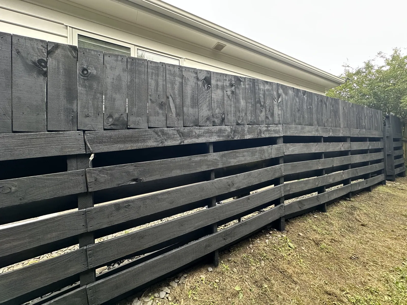 The finished black fence seen from the house side in Sunnyhills