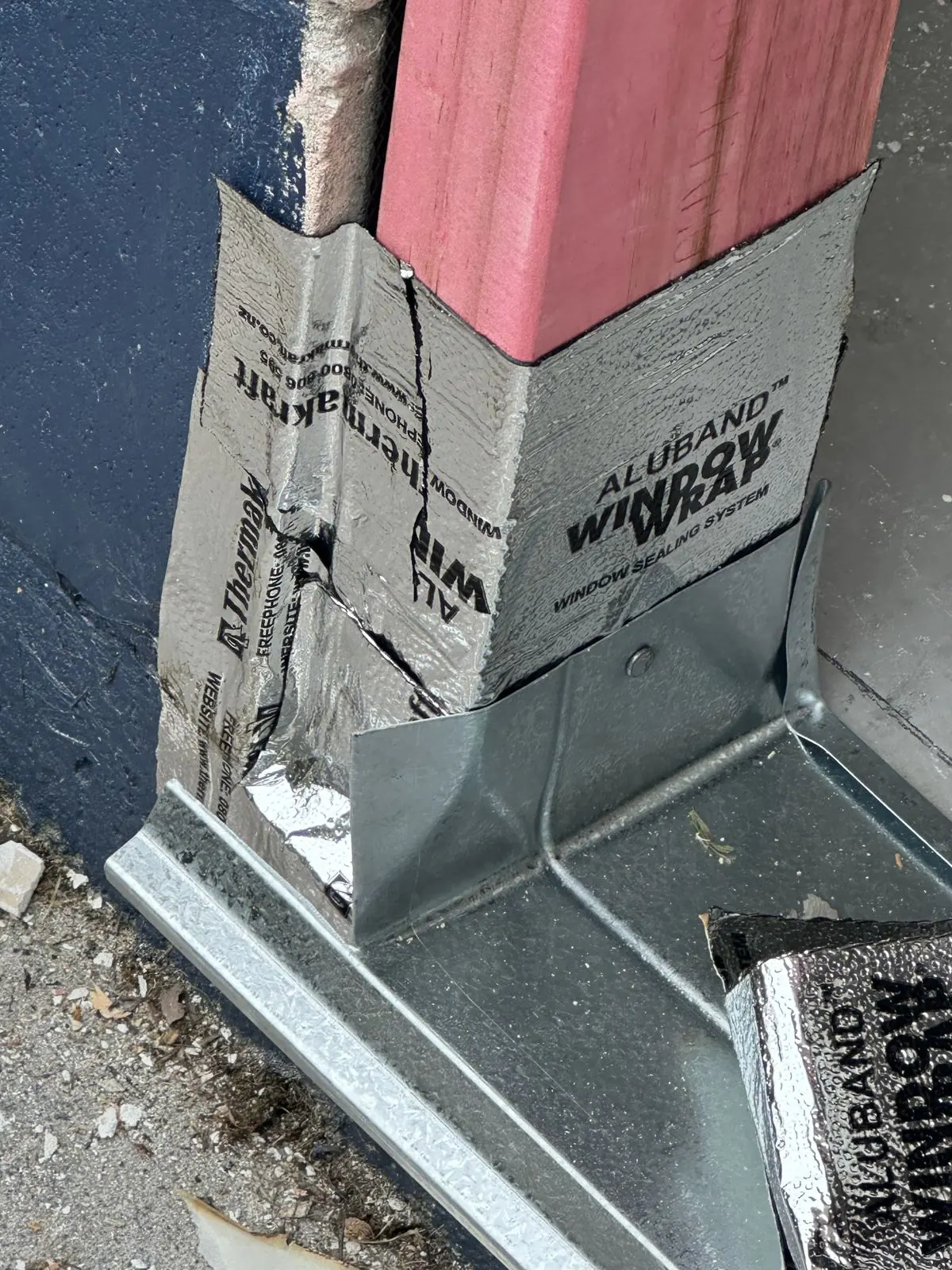 Close-up of flashing tape and sill flashing sealed at the corner of the door opening, Half Moon Bay