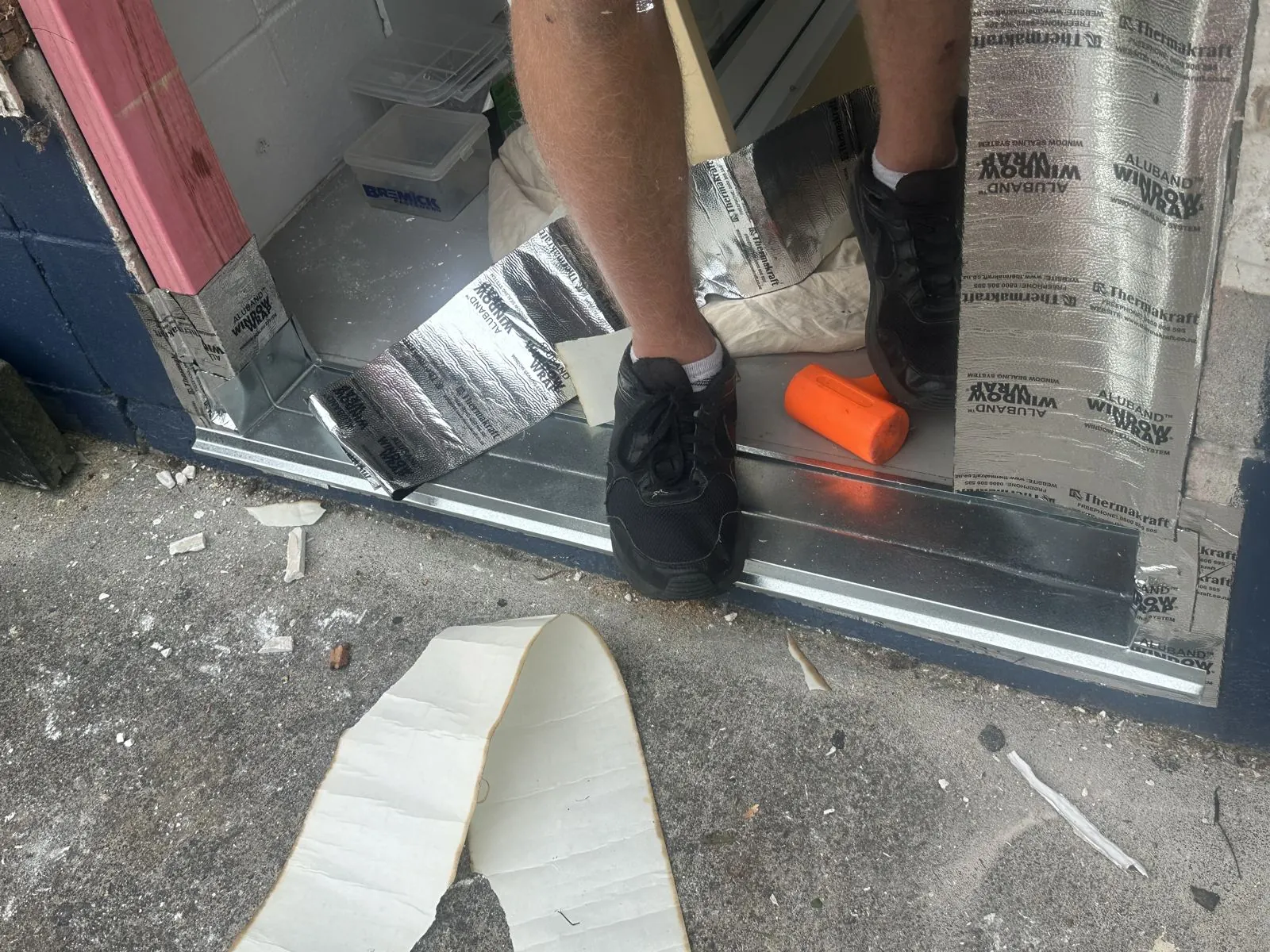 Sill flashing being installed at the base of the door opening before fitting the new door, Half Moon Bay