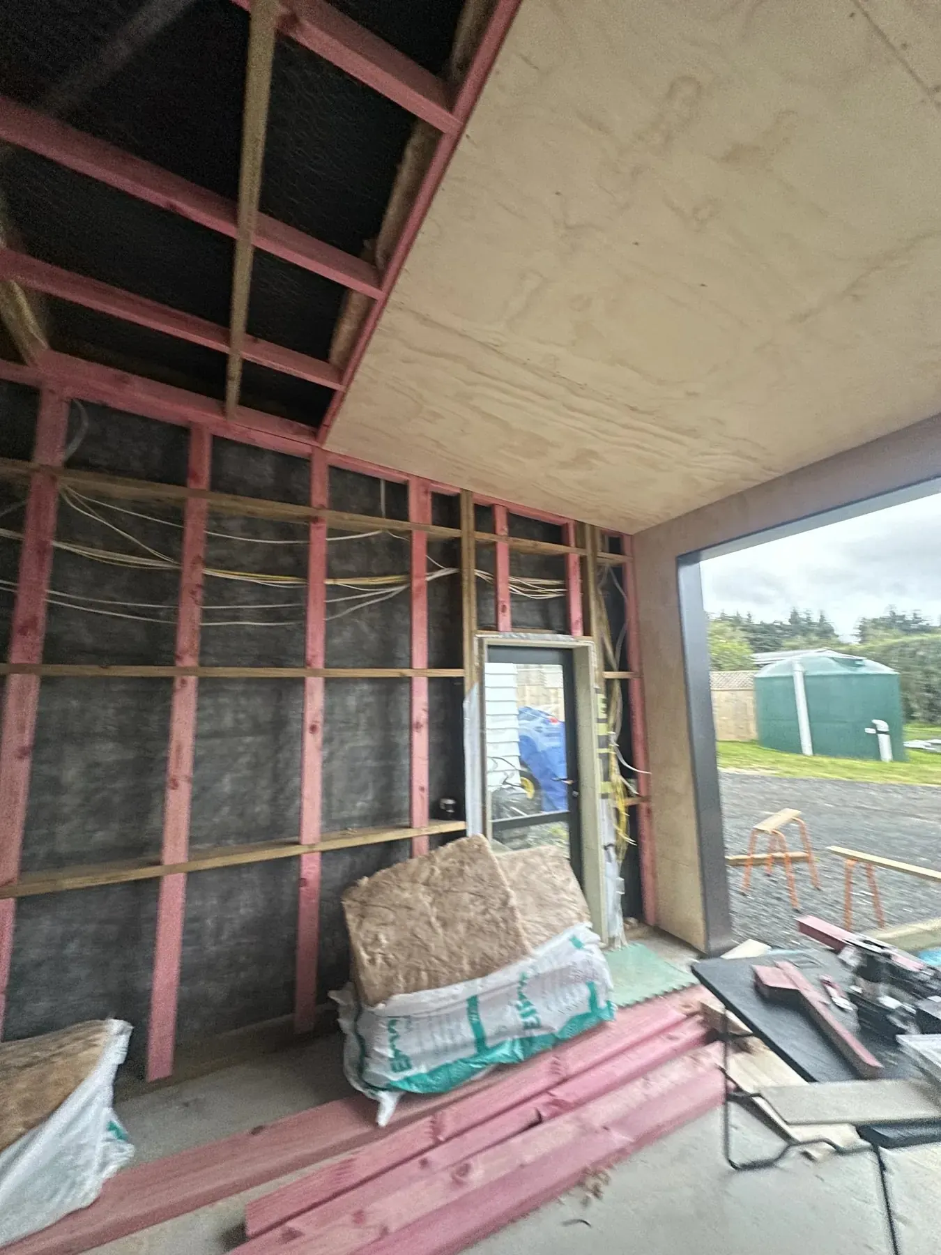 Open timber wall and ceiling framing at the start of a garage interior upgrade in Whenuapai, Auckland