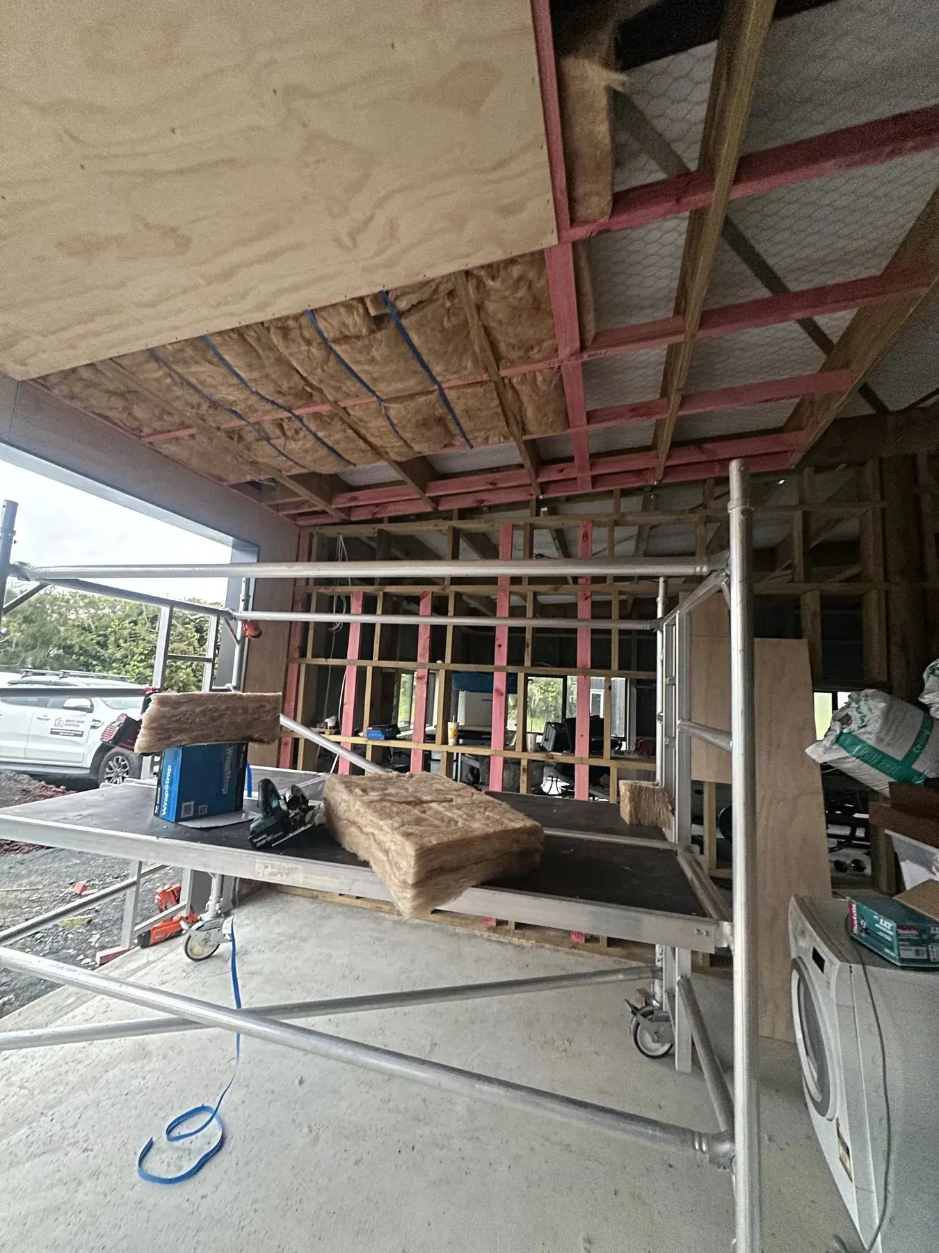 Garage ceiling insulation being installed during a joint Handyman Botany and North Shore Handyman project in Whenuapai
