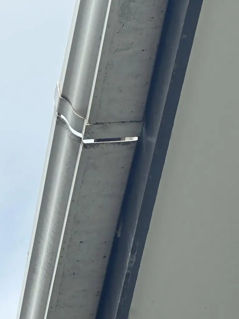Close view of a spouting joint in Howick where two gutter sections have pulled apart, leaving a visible step and gap