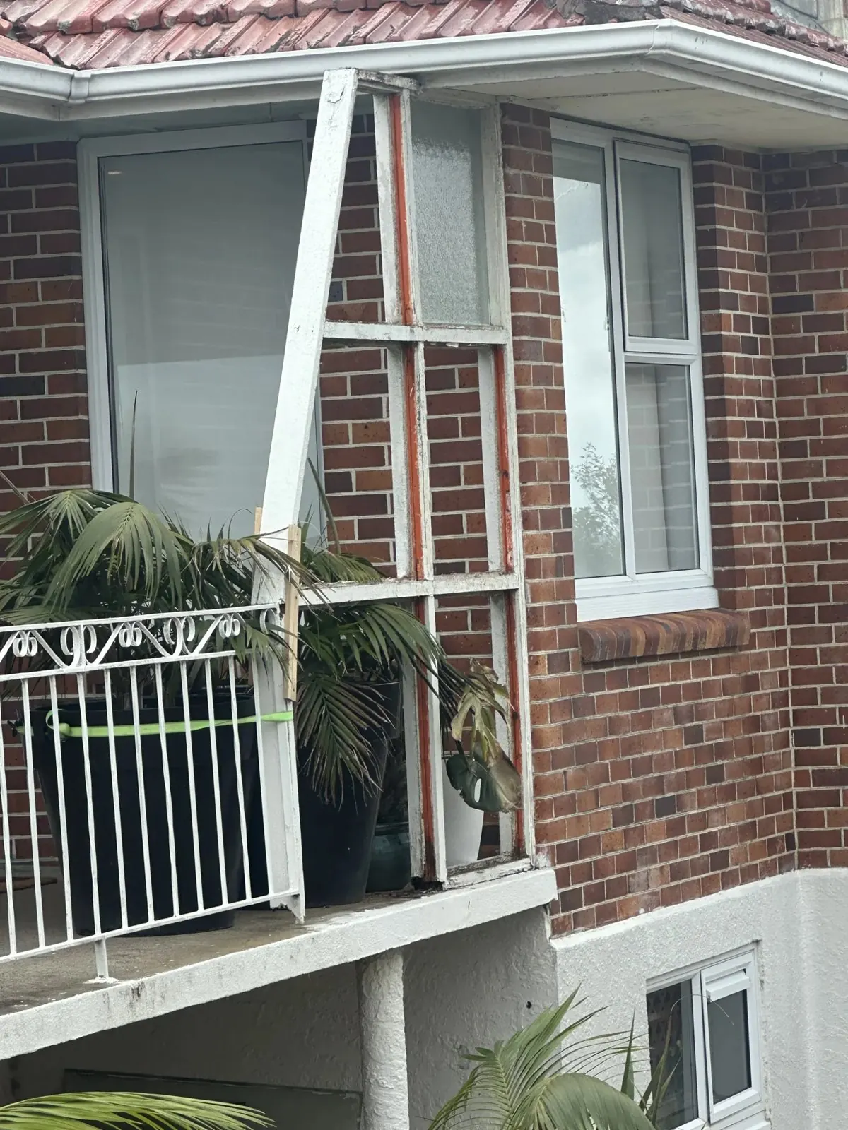 Rotten exterior wall and damaged glazed screen before renovation in Howick