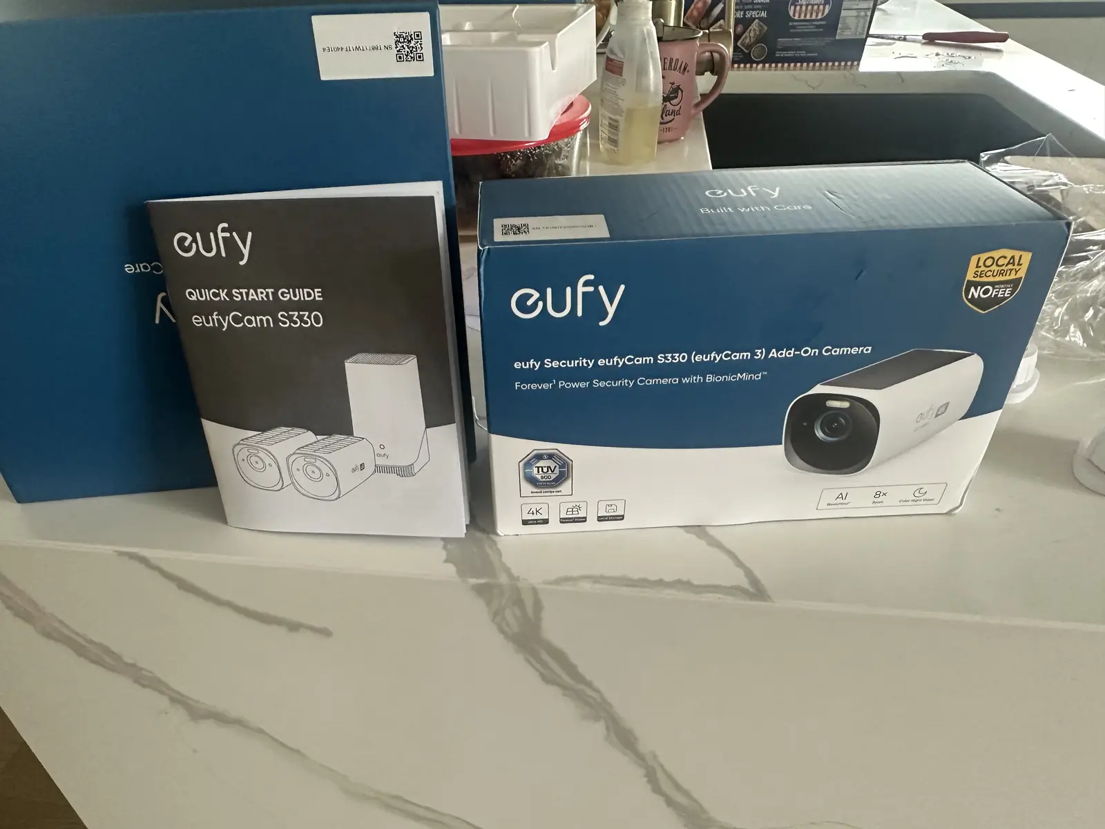 eufyCam S330 kit box with the HomeBase and two cameras, plus an add-on camera box, on a kitchen bench in Sunnyhills