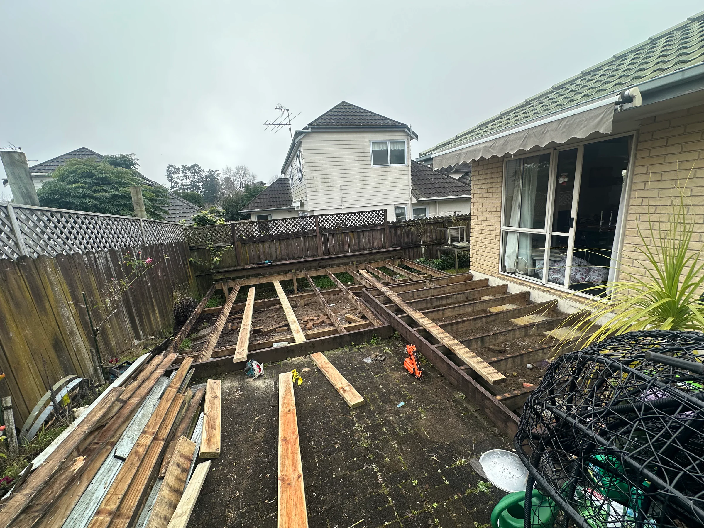 Old decking boards removed to inspect the exposed timber subframe and joists in Botany