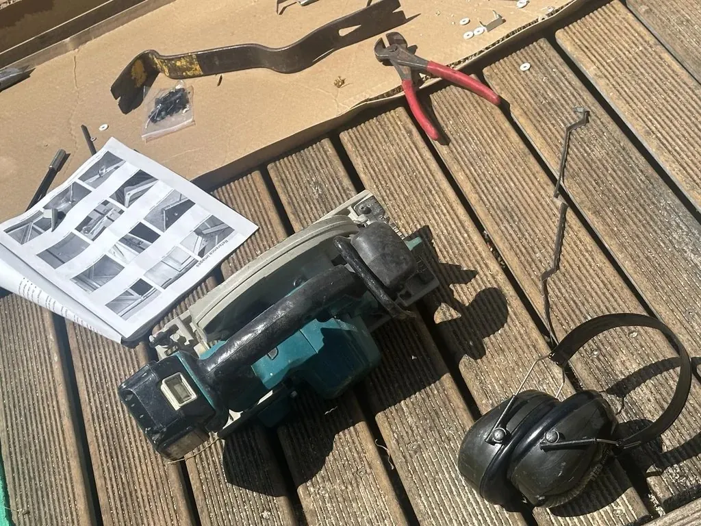 Tools, protective equipment and printed manual prepared for garden shed assembly