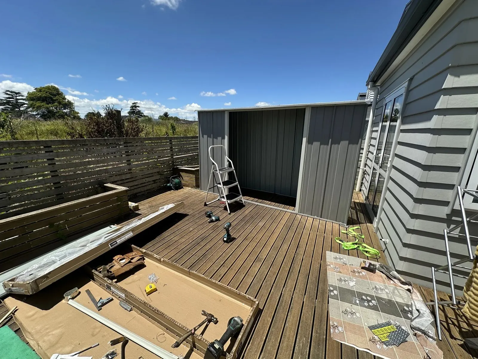 First flat-pack metal garden shed assembled except for final door installation