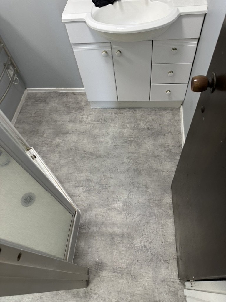 New vinyl flooring in a Botany bathroom cut in tight around the vanity and shower base