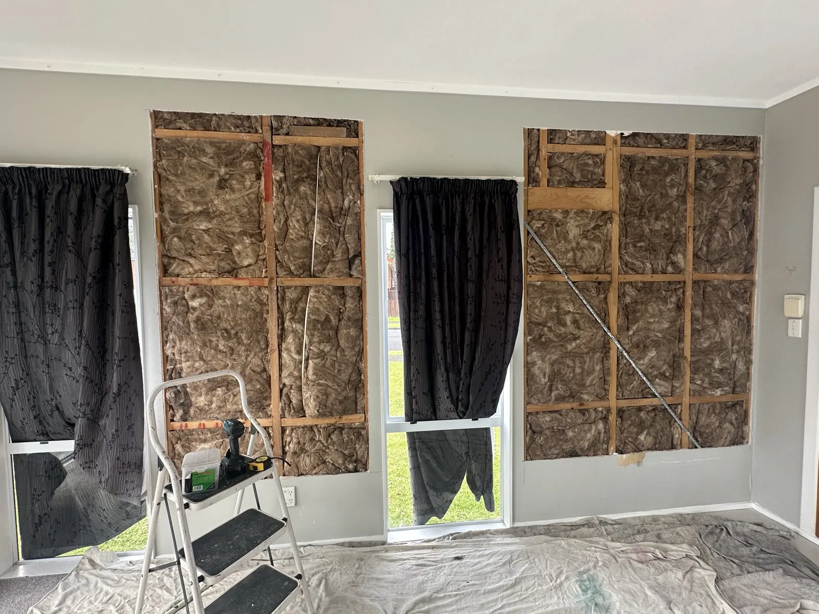 New wool insulation fitted between the studs in both wall openings, Highland Park