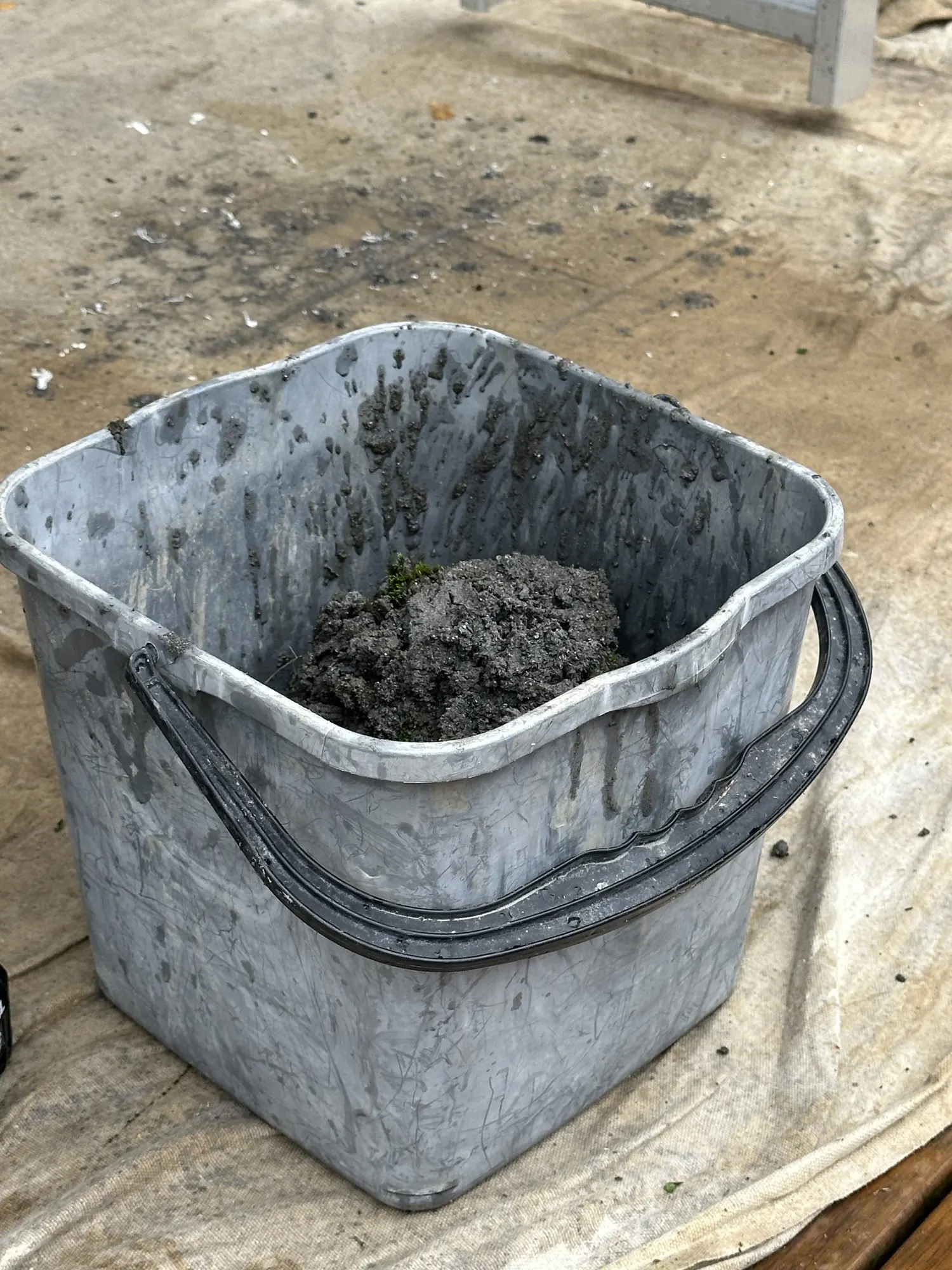 Bucket of heavy sand and organic debris removed from a blocked gutter in Pakuranga Heights