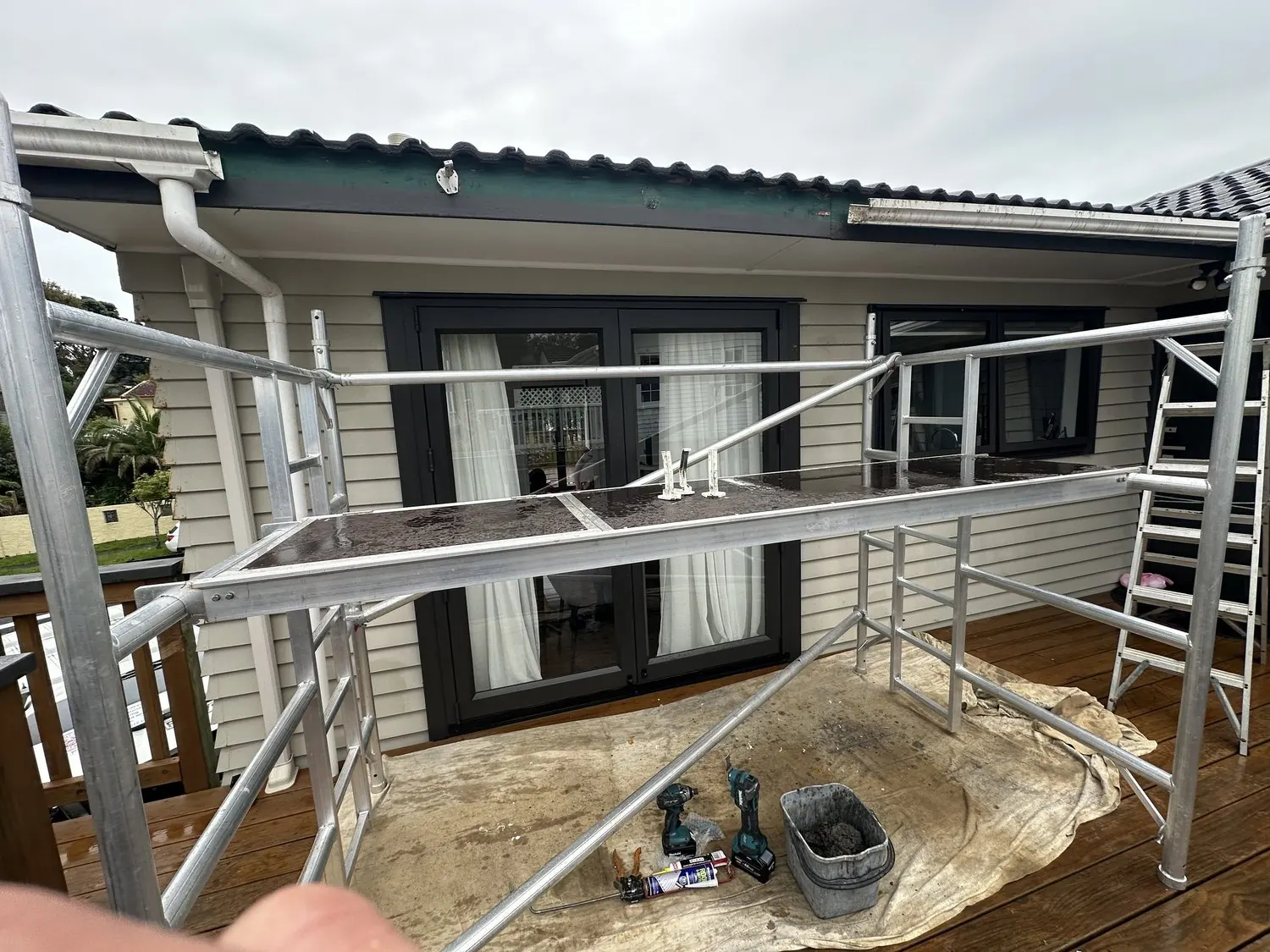 Mobile scaffold set up safely while a gutter section is removed for repair in Pakuranga Heights